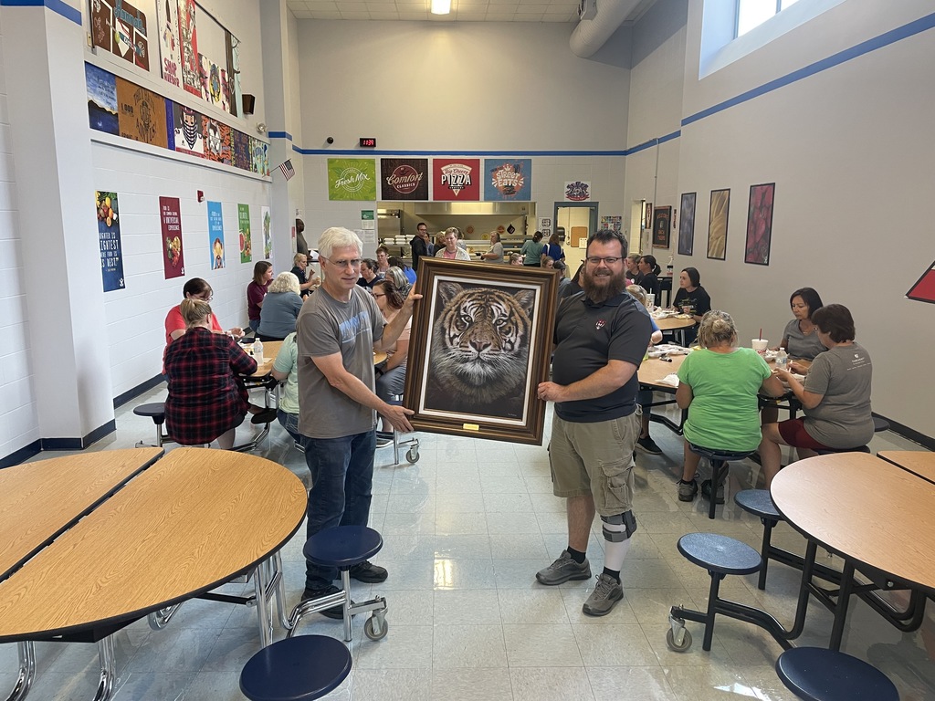 Mr. Altenburg presenting his tiger painting to the school. 2021